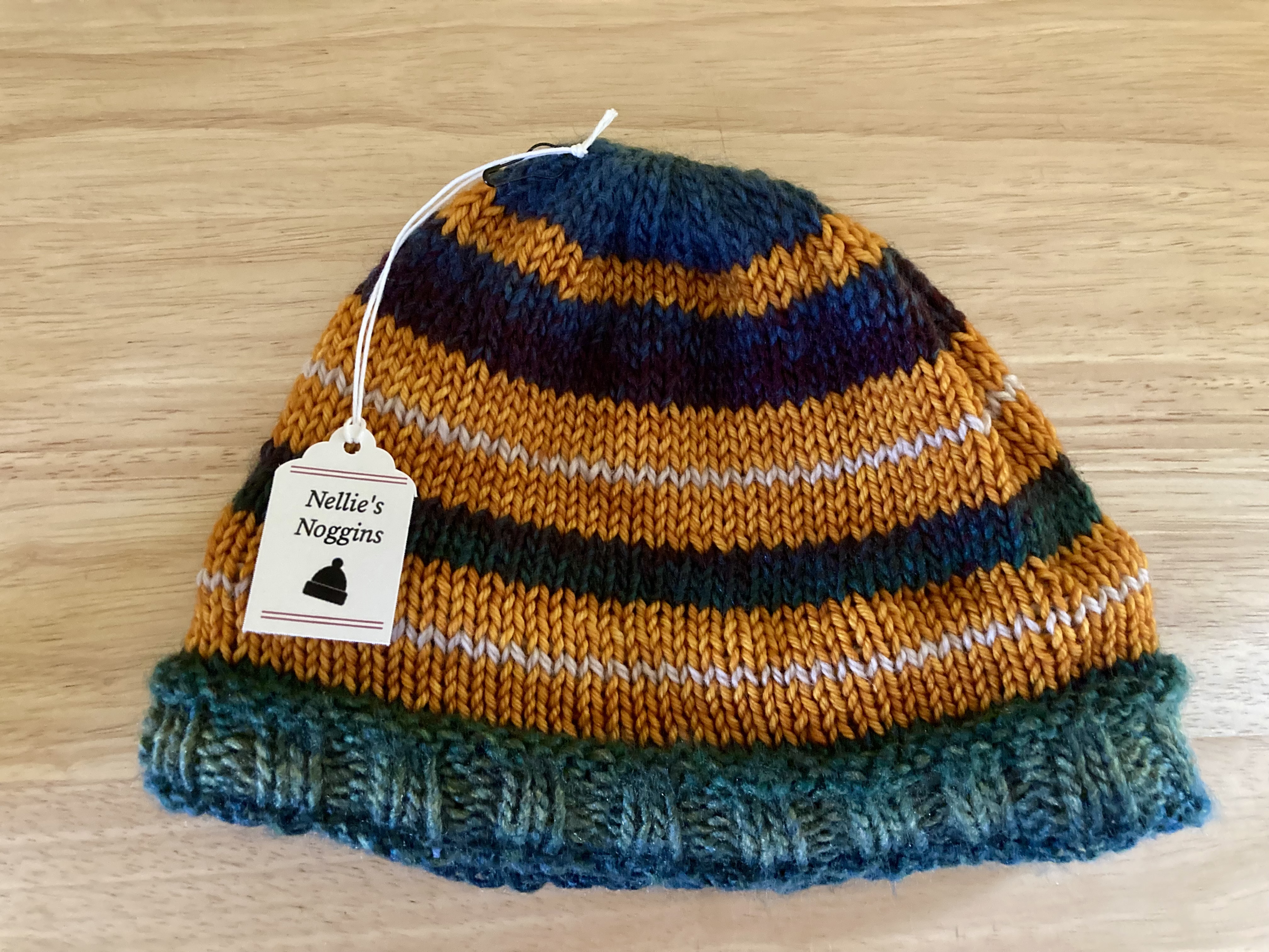 green, yellow, blue, and white striped knitted cap